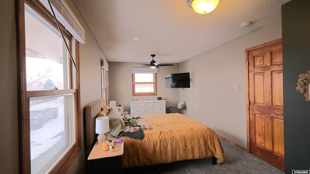 bedroom featuring carpet flooring, ceiling fan, and a textured ceiling