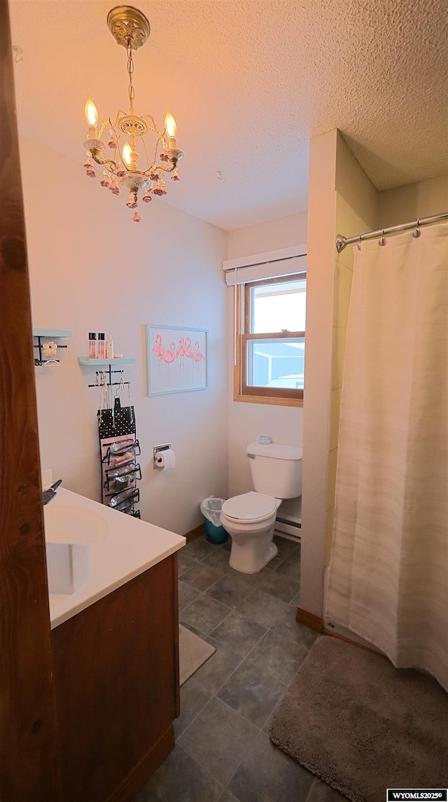 bathroom with vanity, toilet, a textured ceiling, and a chandelier