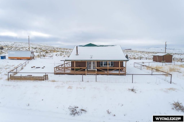 view of snow covered rear of property