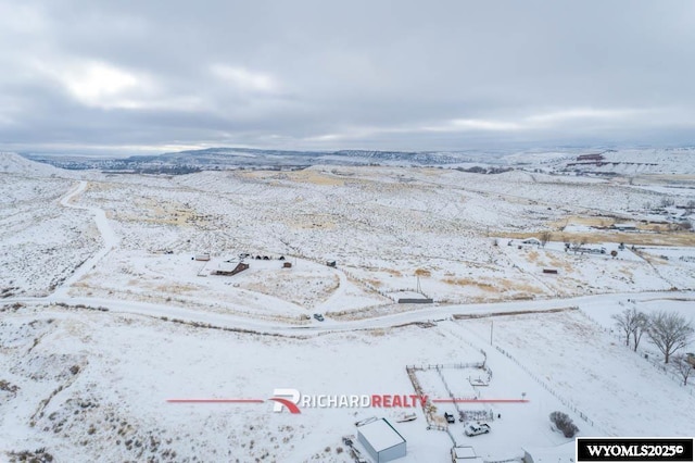 snowy aerial view with a mountain view