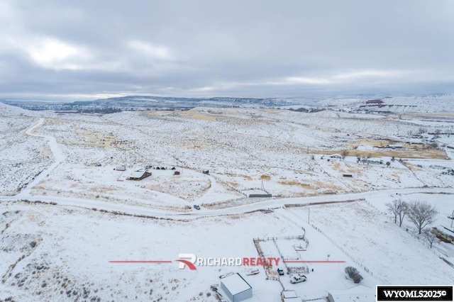 snowy aerial view with a mountain view