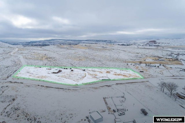 snowy aerial view with a mountain view