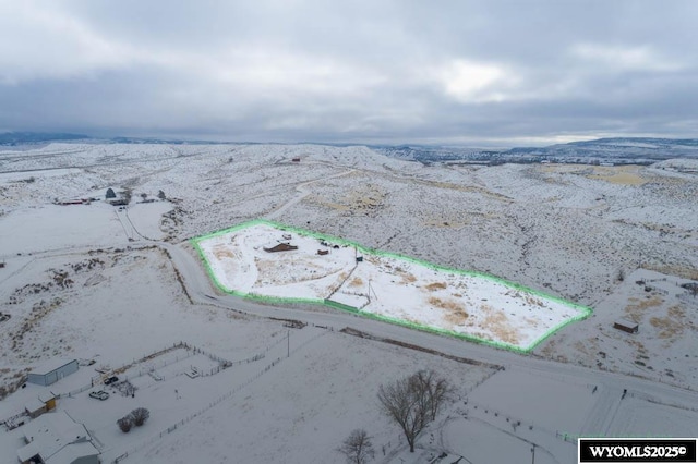 snowy aerial view with a mountain view