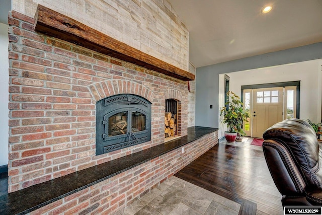 living room featuring a brick fireplace