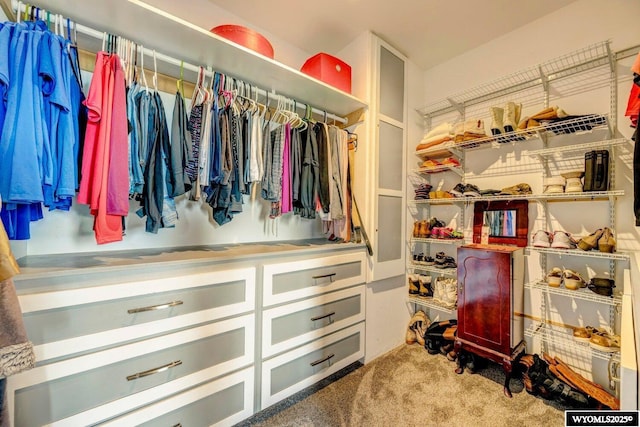 walk in closet featuring light carpet