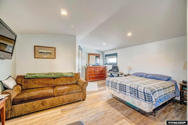 bedroom with light hardwood / wood-style flooring and lofted ceiling