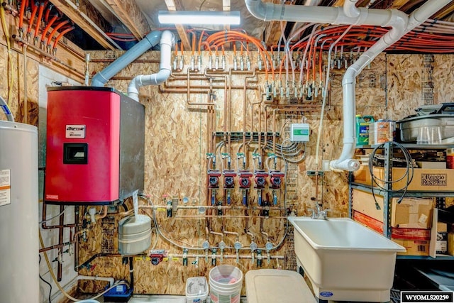 utility room featuring tankless water heater and water heater