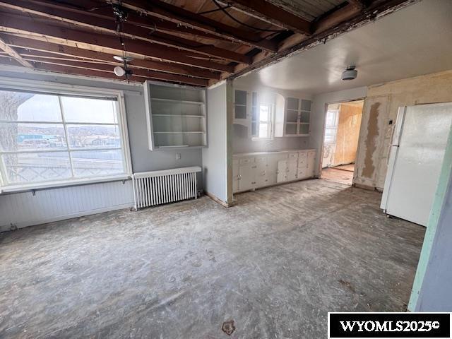 interior space with radiator heating unit and concrete flooring