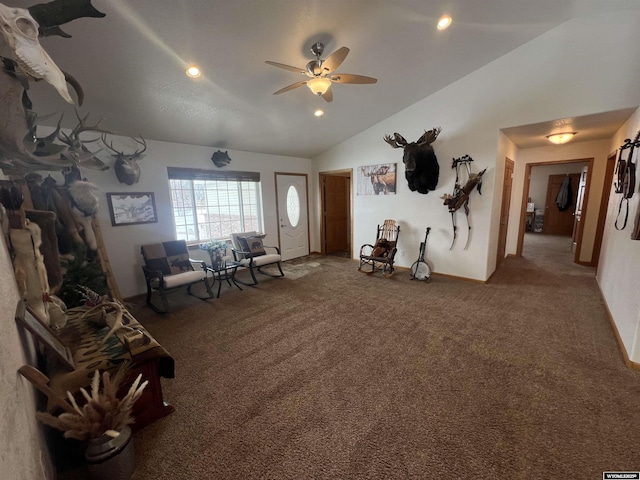 living room with carpet floors, vaulted ceiling, and ceiling fan