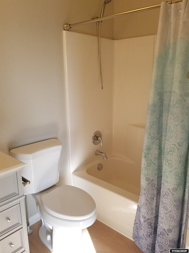 full bathroom featuring vanity, shower / bath combo, and toilet