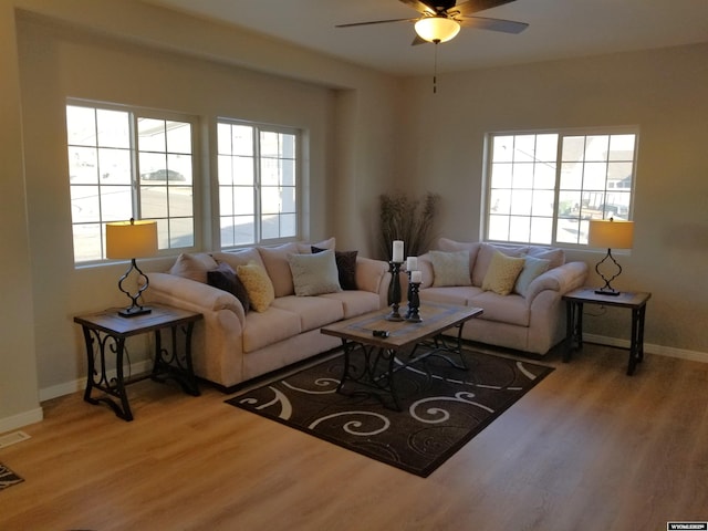 living room with light hardwood / wood-style flooring and ceiling fan