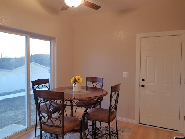 dining area with a mountain view, hardwood / wood-style floors, and ceiling fan