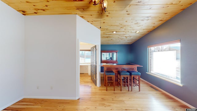 dining area featuring lofted ceiling, wood ceiling, and light hardwood / wood-style flooring