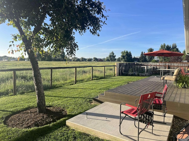 view of yard with a rural view and a deck