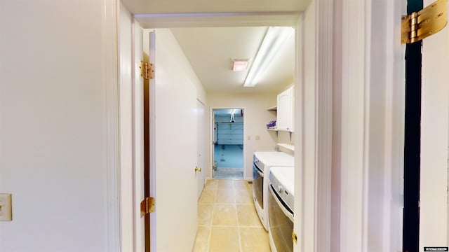 laundry room with washer and clothes dryer and light tile patterned flooring