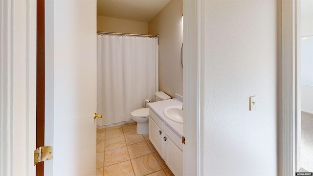 bathroom with tile patterned flooring, vanity, and toilet