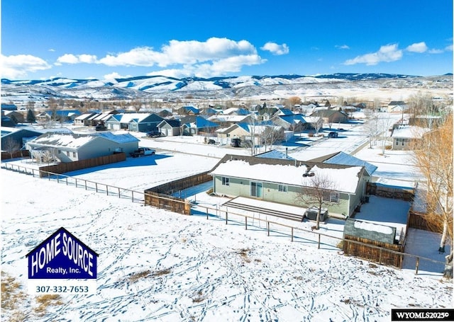 snowy aerial view with a mountain view