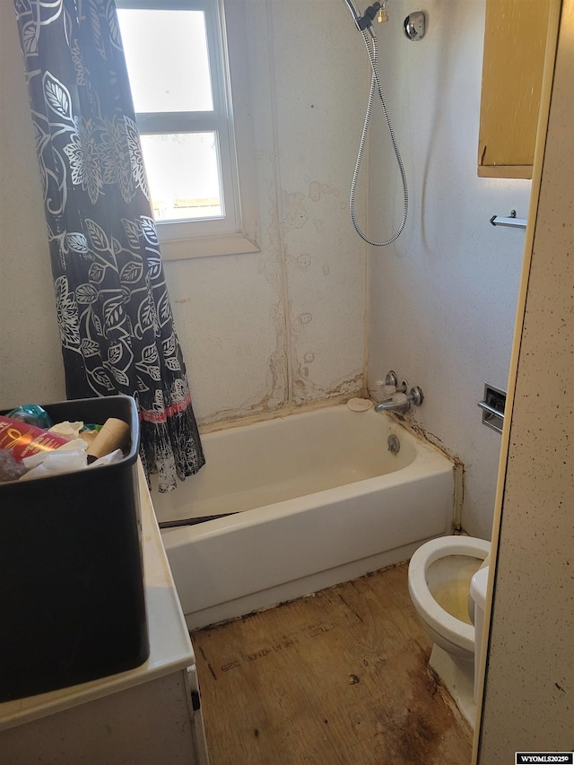 bathroom featuring shower / tub combo and toilet