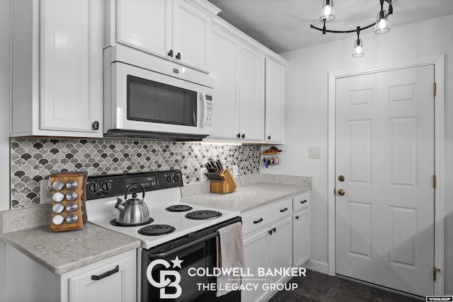 kitchen featuring white cabinetry, light stone countertops, and white appliances