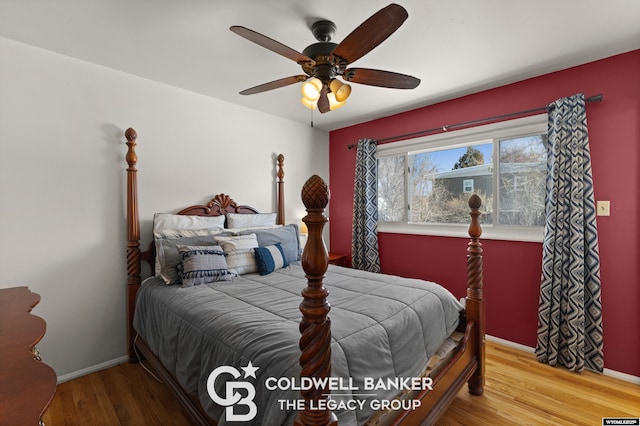 bedroom with hardwood / wood-style floors and ceiling fan