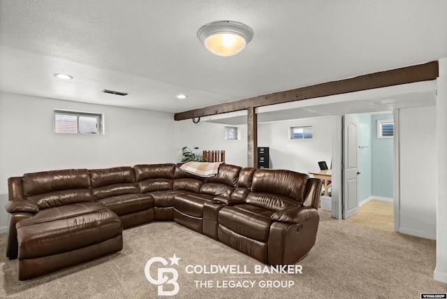 carpeted cinema room featuring a textured ceiling