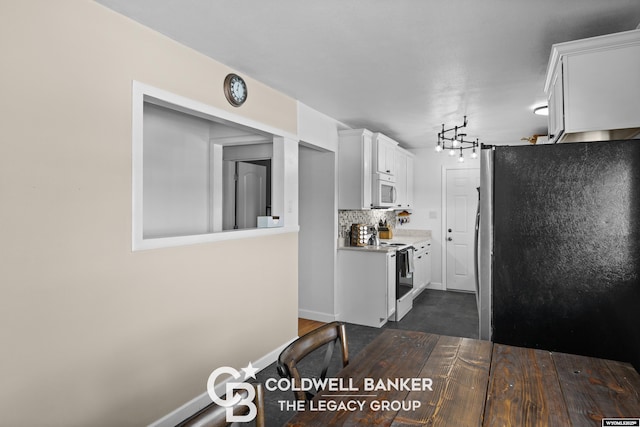 kitchen with white cabinets, dark hardwood / wood-style flooring, white appliances, and tasteful backsplash