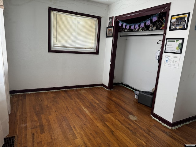 unfurnished room featuring dark wood-type flooring