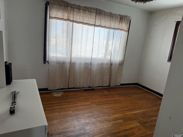 spare room with dark hardwood / wood-style floors