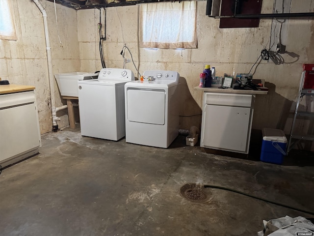 washroom with independent washer and dryer and sink