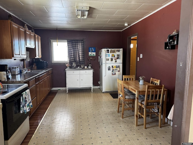 kitchen featuring white appliances, sink, and ornamental molding