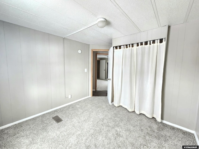 unfurnished room featuring carpet