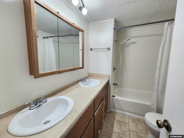 full bathroom with vanity, shower / bath combination with curtain, and toilet