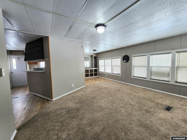 unfurnished living room with carpet floors