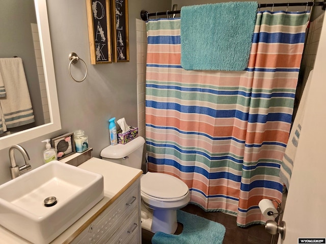 bathroom featuring walk in shower, vanity, and toilet