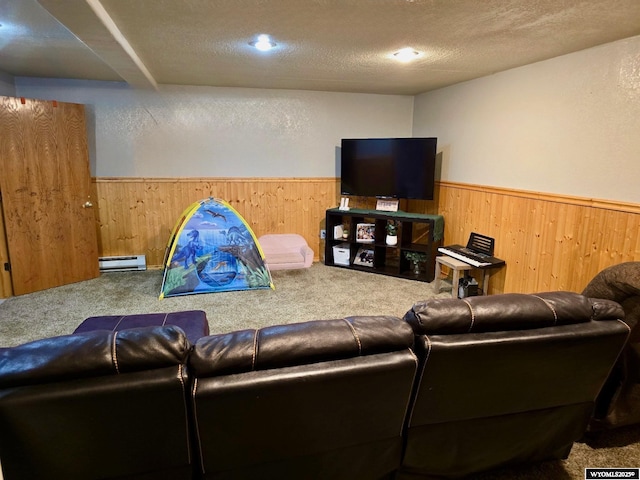 living room with carpet flooring, baseboard heating, and a textured ceiling