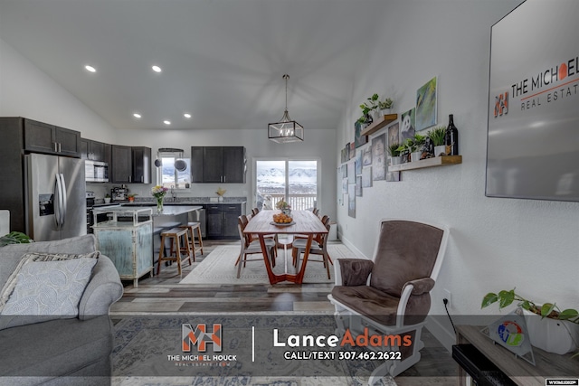 interior space featuring vaulted ceiling, light wood-type flooring, baseboards, and recessed lighting