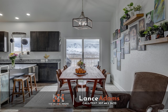 dining space featuring baseboards, recessed lighting, plenty of natural light, and an inviting chandelier