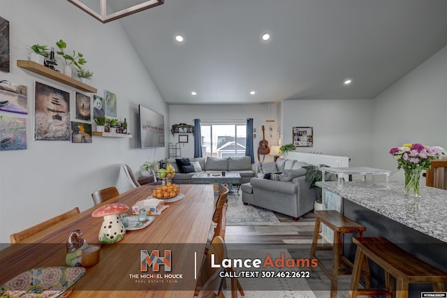 dining area with vaulted ceiling, wood finished floors, and recessed lighting