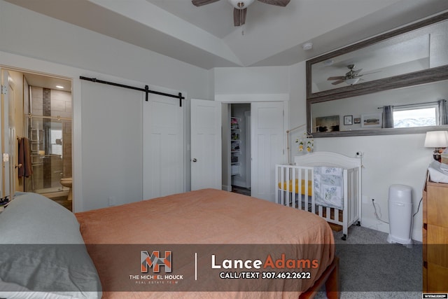 bedroom featuring carpet and a barn door