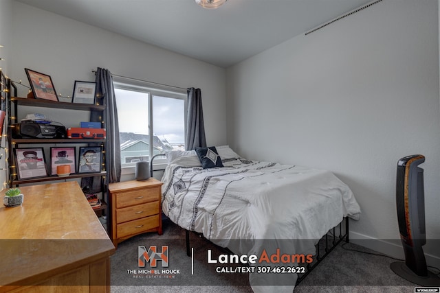 bedroom featuring dark carpet