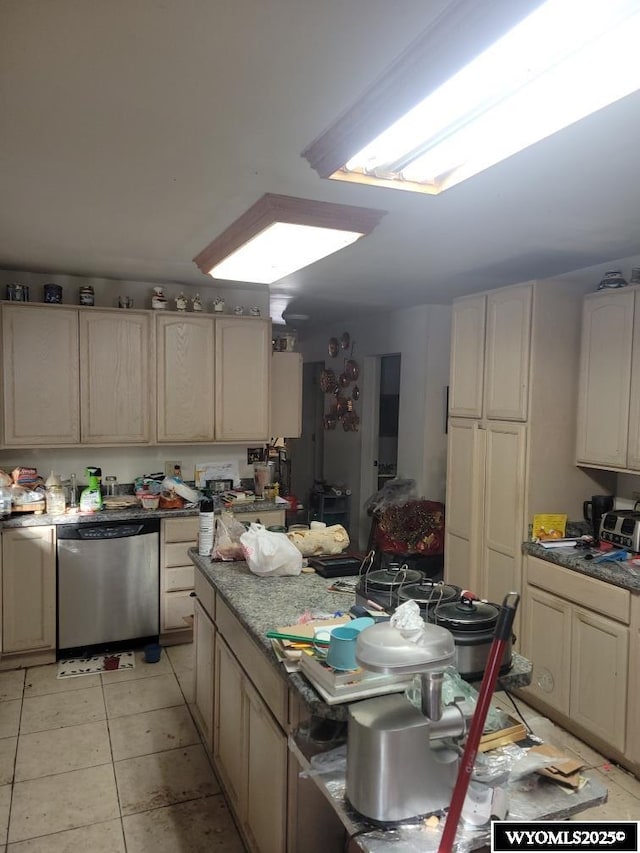 kitchen featuring stainless steel dishwasher and light tile patterned floors