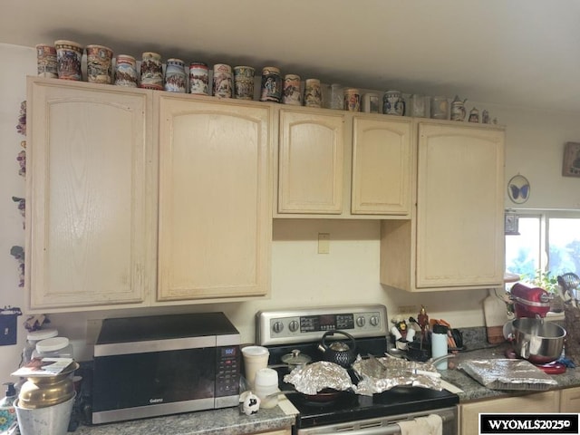 kitchen with stainless steel appliances and cream cabinetry