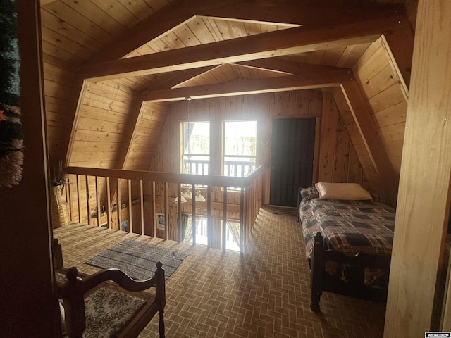 bedroom featuring lofted ceiling with beams, wood ceiling, and wooden walls