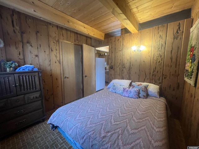 bedroom featuring wood ceiling, white fridge, beamed ceiling, and wooden walls