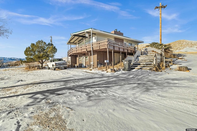 view of front of property featuring a deck with mountain view