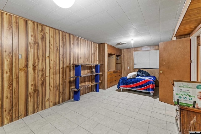 basement featuring wood walls