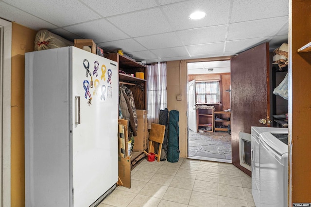 kitchen with washer / clothes dryer, light tile patterned floors, a paneled ceiling, and white refrigerator