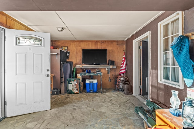 entryway with wood walls