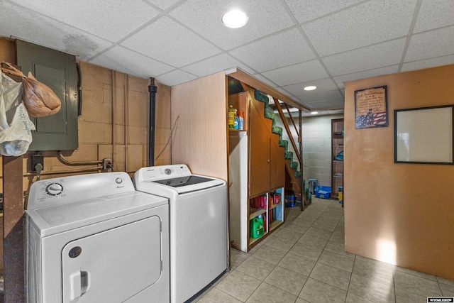 washroom featuring washing machine and dryer and light tile patterned flooring