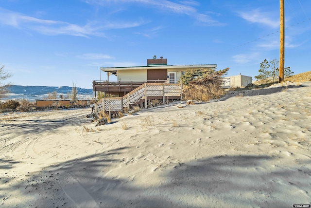 view of front of house with a deck with mountain view